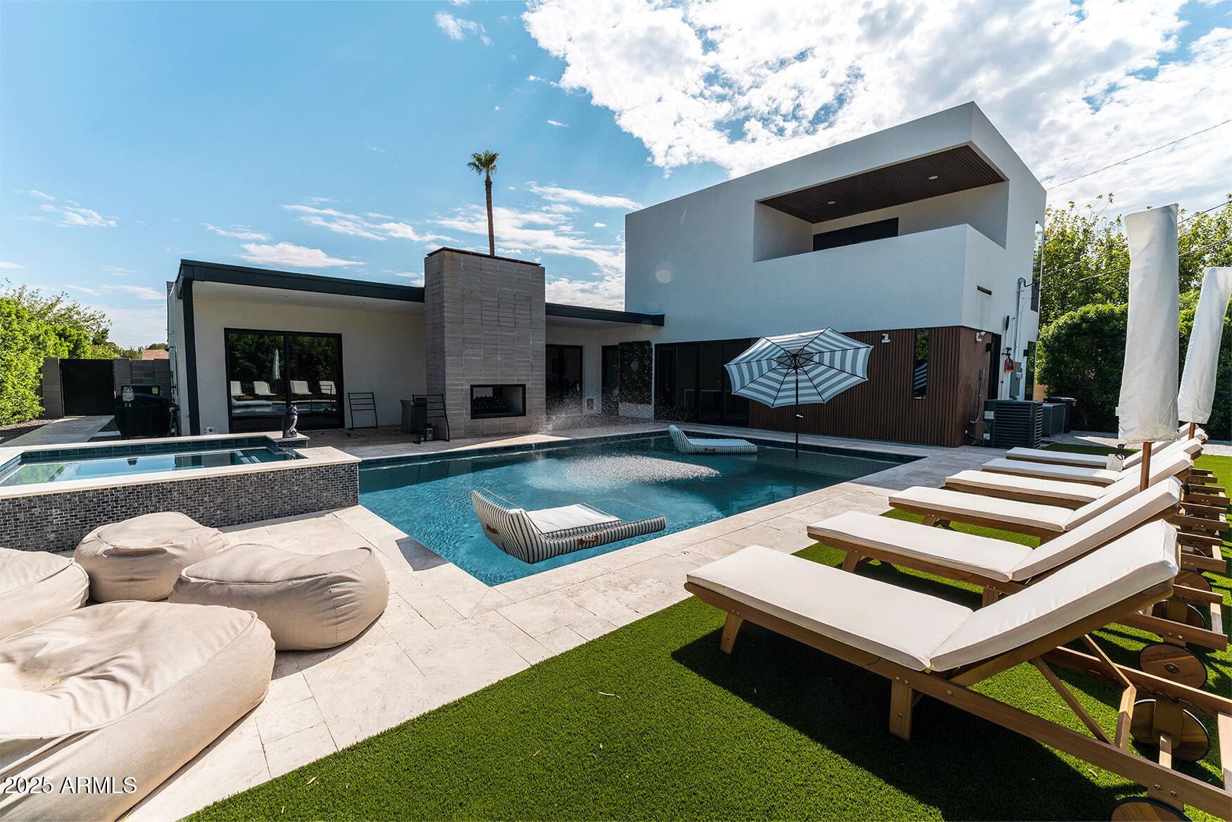 a view of a patio with couches table and chairs with potted plants
