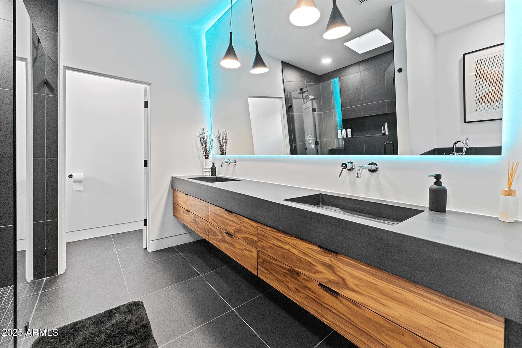 4334 East Lewis Avenue Phoenix, AZ 85008 - Photo 12 of 26 a spacious bathroom with a sink and a mirror