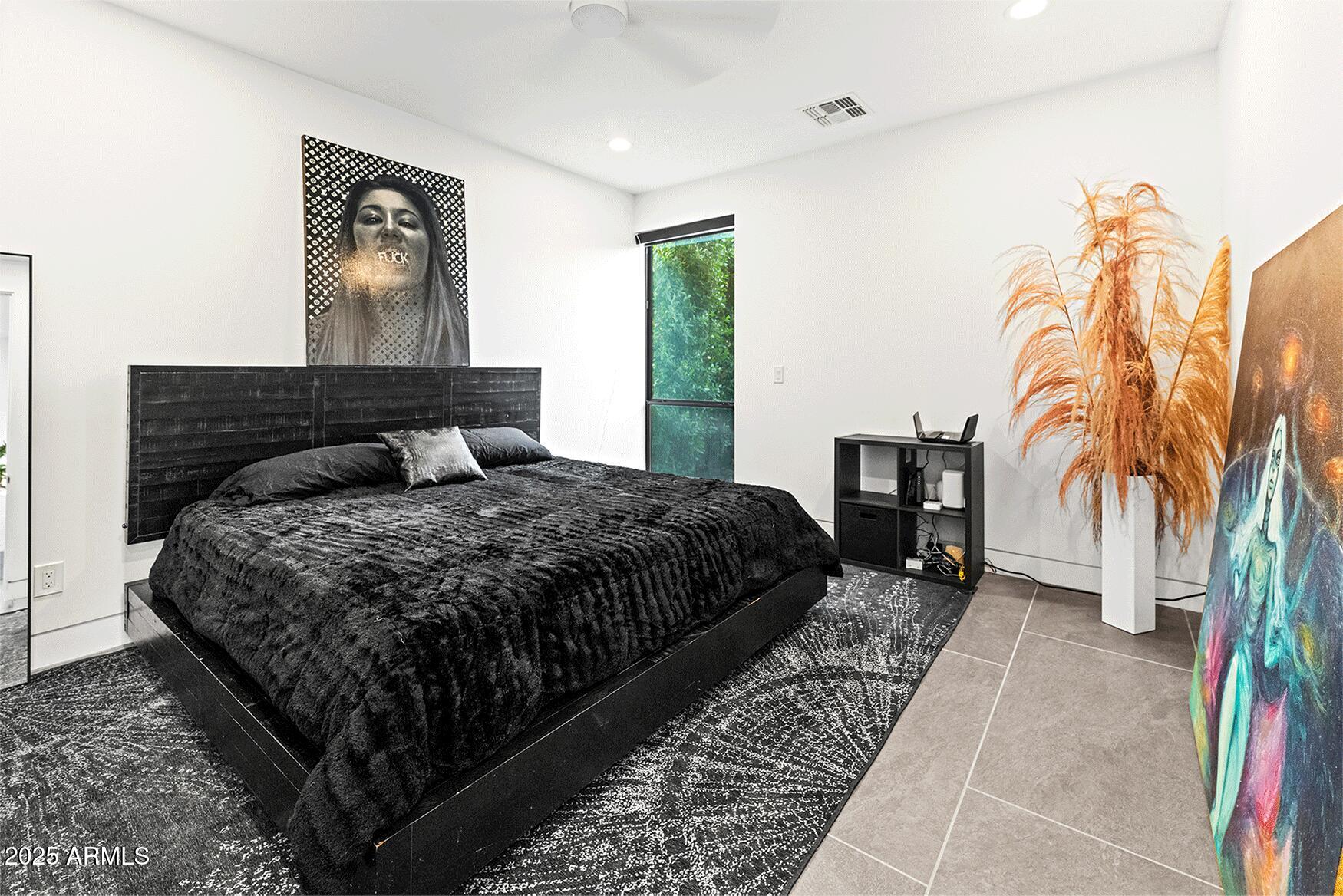 4334 East Lewis Avenue Phoenix, AZ 85008 - Photo 16 of 26 a bedroom with a bed lamp and a potted plant