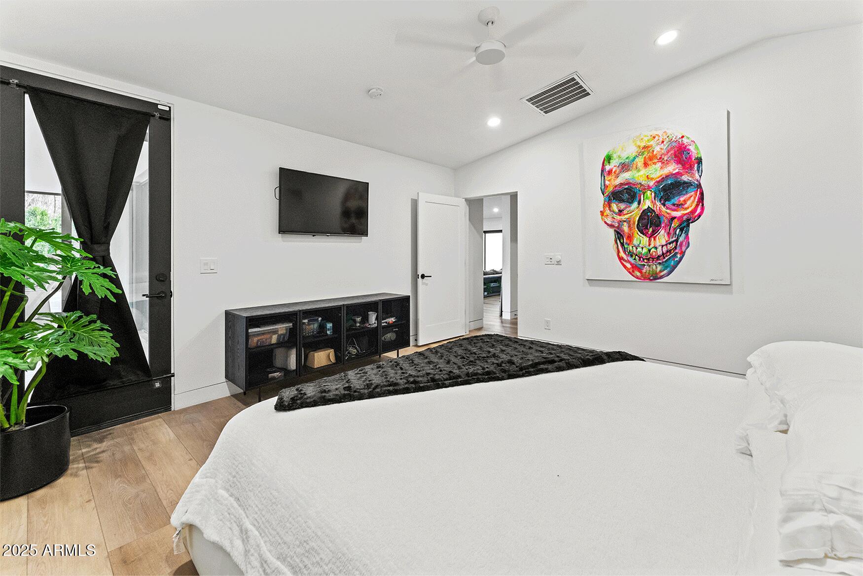 4334 East Lewis Avenue Phoenix, AZ 85008 - Photo 17 of 26 a bedroom with a bed and a flat screen tv