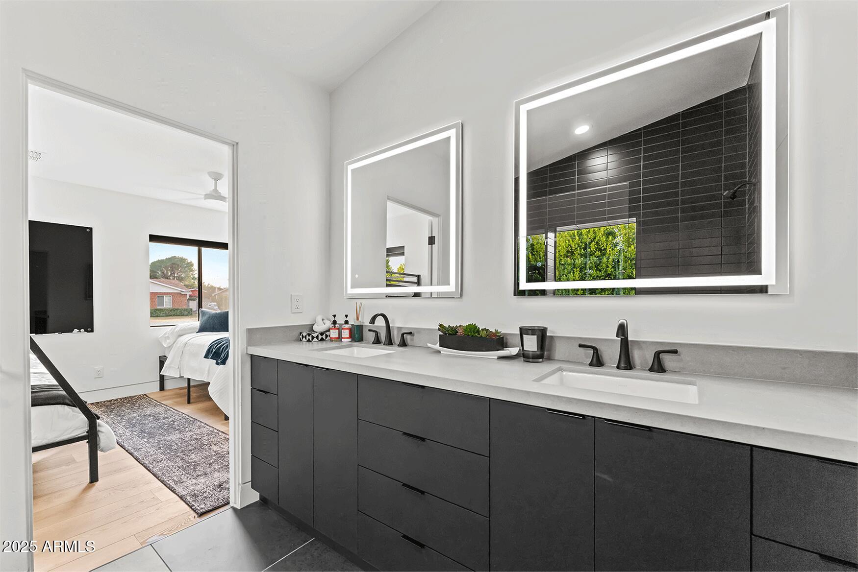 4334 East Lewis Avenue Phoenix, AZ 85008 - Photo 19 of 26 a bathroom with a double vanity sink and mirror