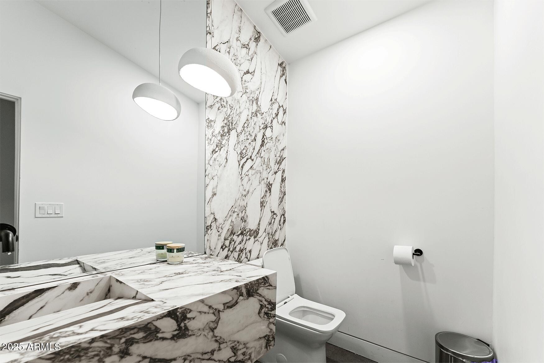 4334 East Lewis Avenue Phoenix, AZ 85008 - Photo 20 of 26 a bathroom with a sink a toilet and shower curtain