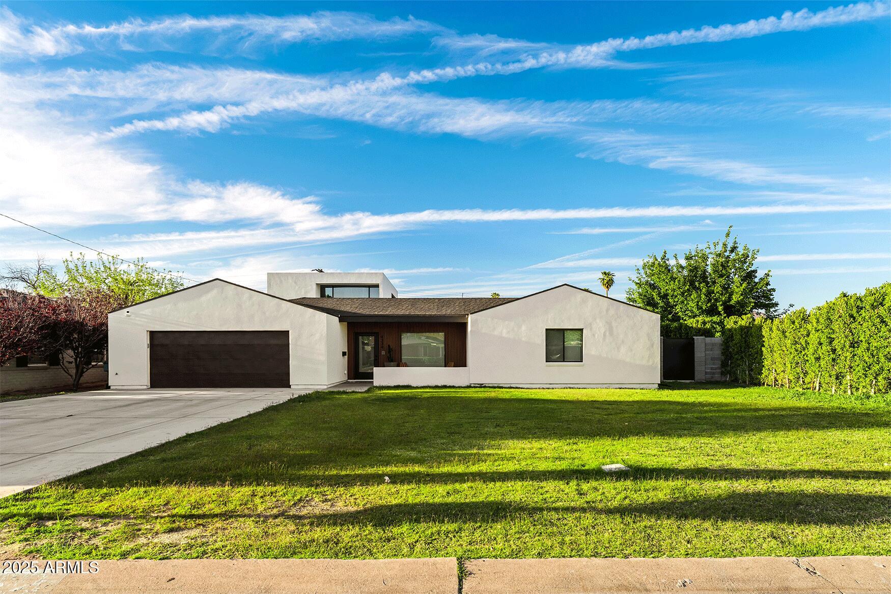 4334 East Lewis Avenue Phoenix, AZ 85008 - Photo 26 of 26 a front view of a house with a garden