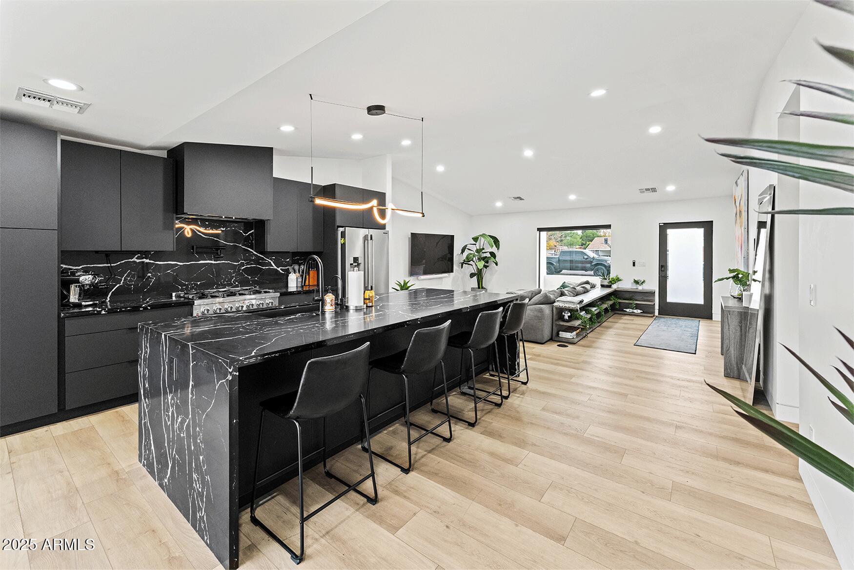 4334 East Lewis Avenue Phoenix, AZ 85008 - Photo 5 of 26 a kitchen with stainless steel appliances granite countertop a refrigerator a stove and a sink