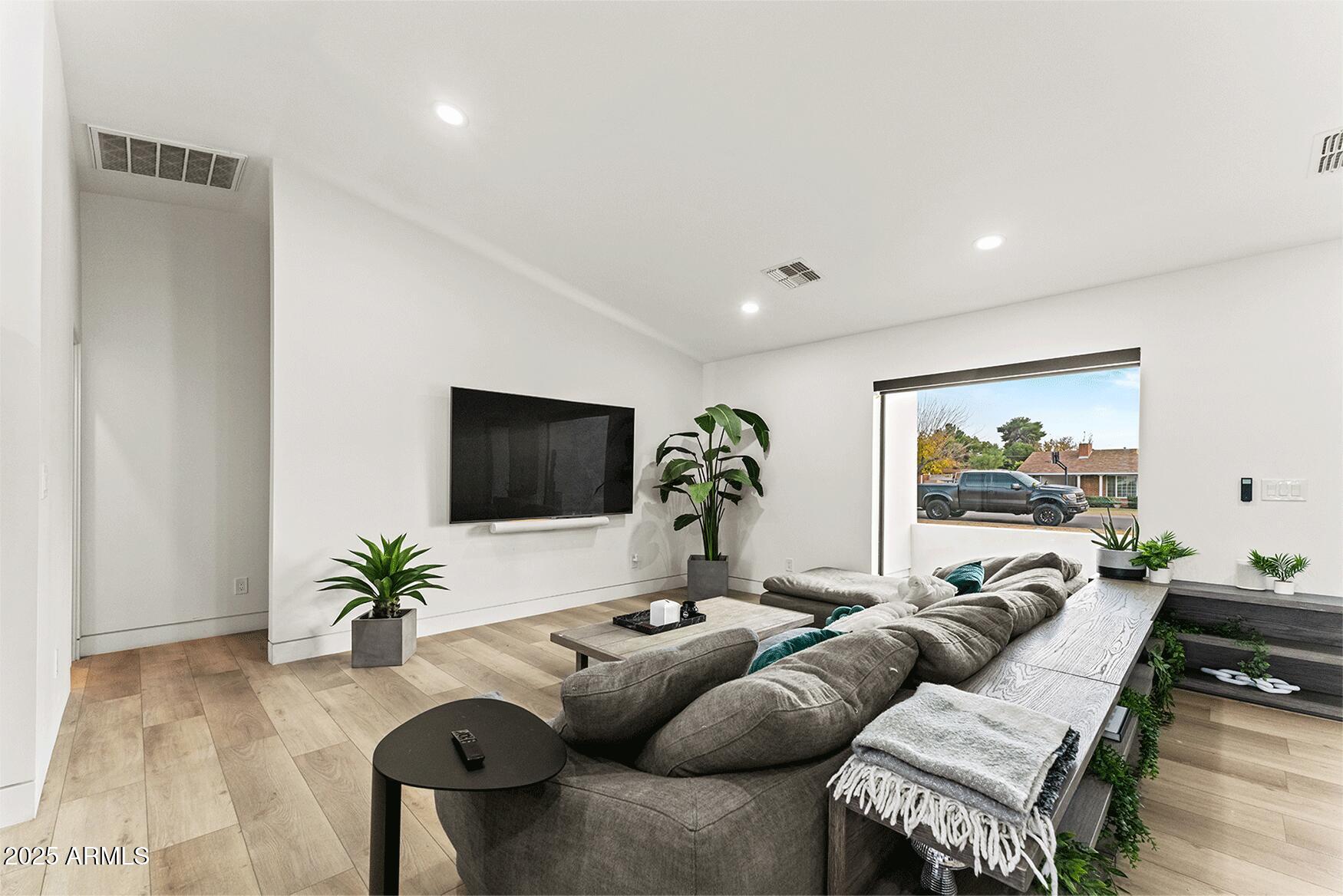 4334 East Lewis Avenue Phoenix, AZ 85008 - Photo 6 of 26 a living room with furniture and a flat screen tv