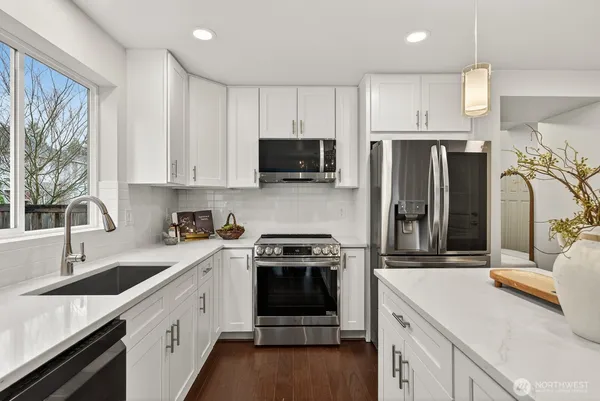a kitchen with a sink stove and refrigerator