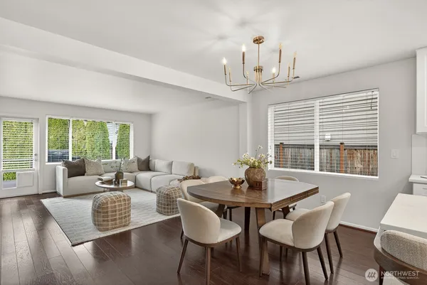 a view of a dining room with furniture wooden floor and a chandelier