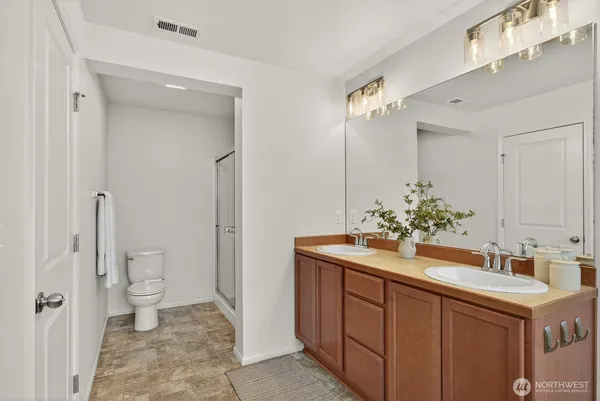 a bathroom with a sink vanity granite and toilet