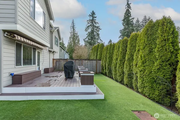 a view of backyard with seating area and green space