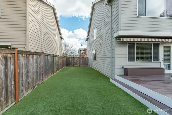 a view of a backyard with sitting area