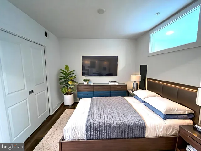 a bedroom with a bed and a flat screen tv