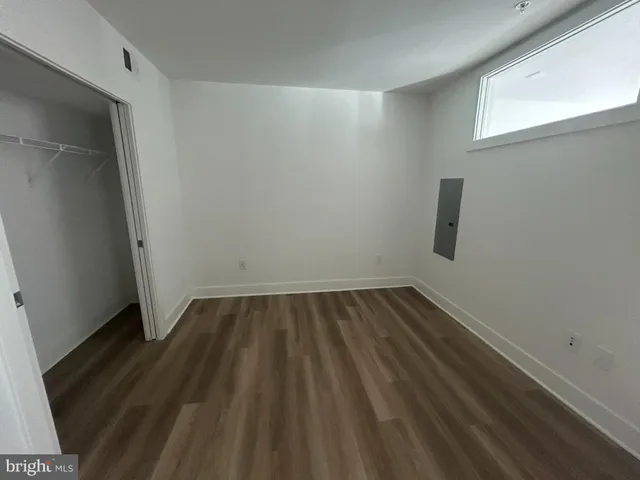 a view of a room with wooden floor