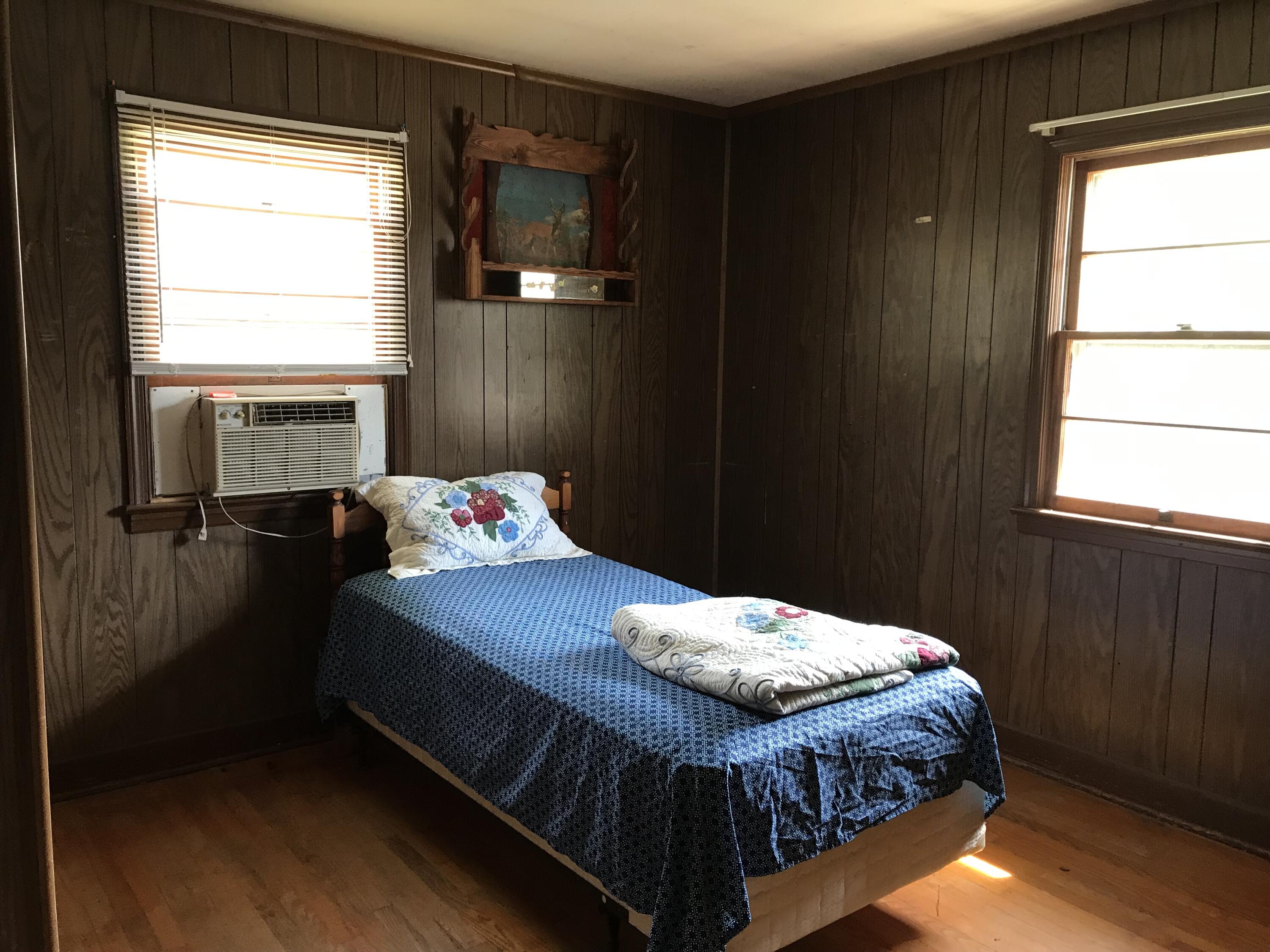 8180 Chatham Road Martinsville, VA 24112 - Photo 11 of 22 a bedroom with a bed and wooden floor