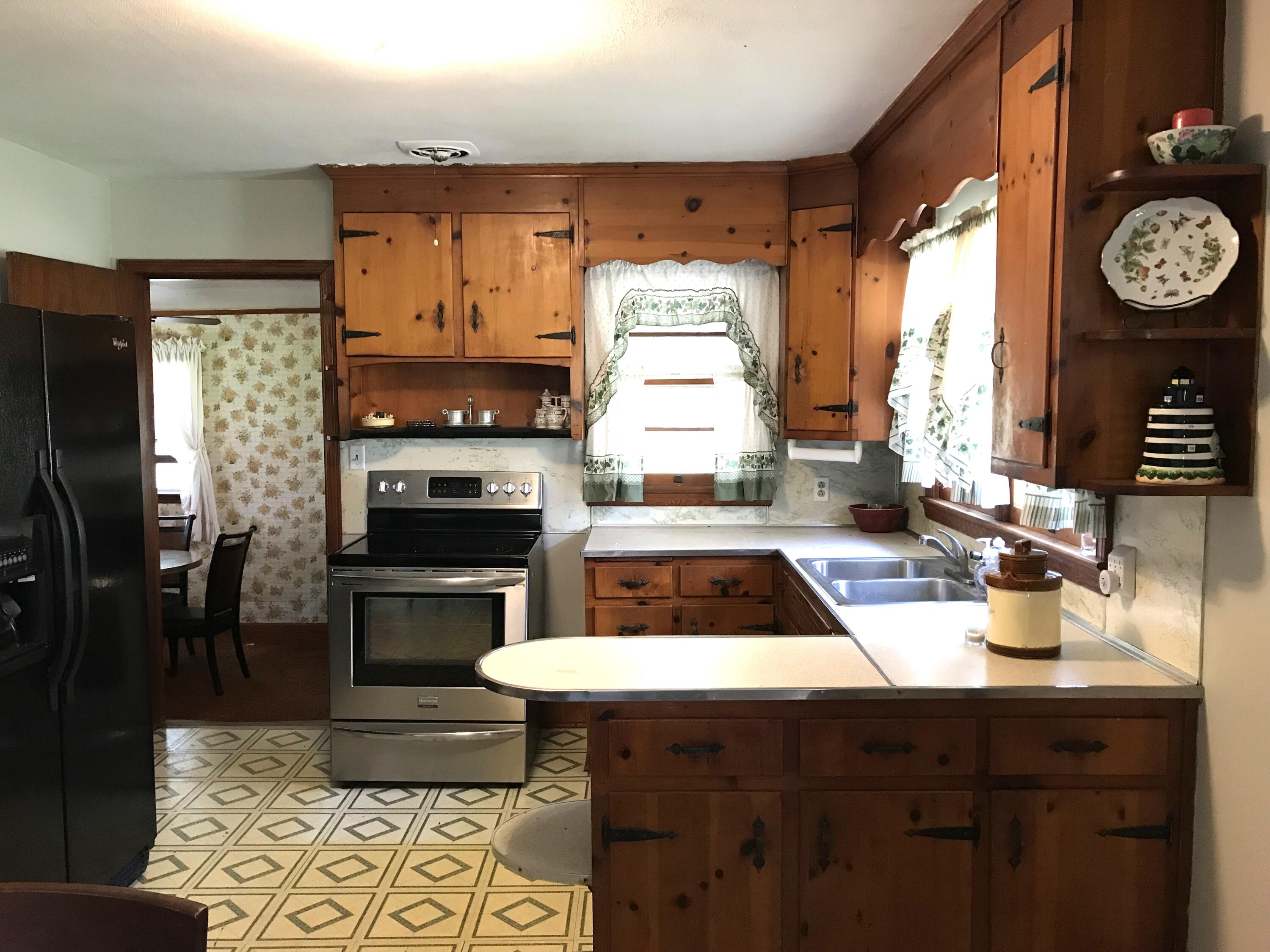 8180 Chatham Road Martinsville, VA 24112 - Photo 5 of 22 a kitchen with a stove a refrigerator and a sink
