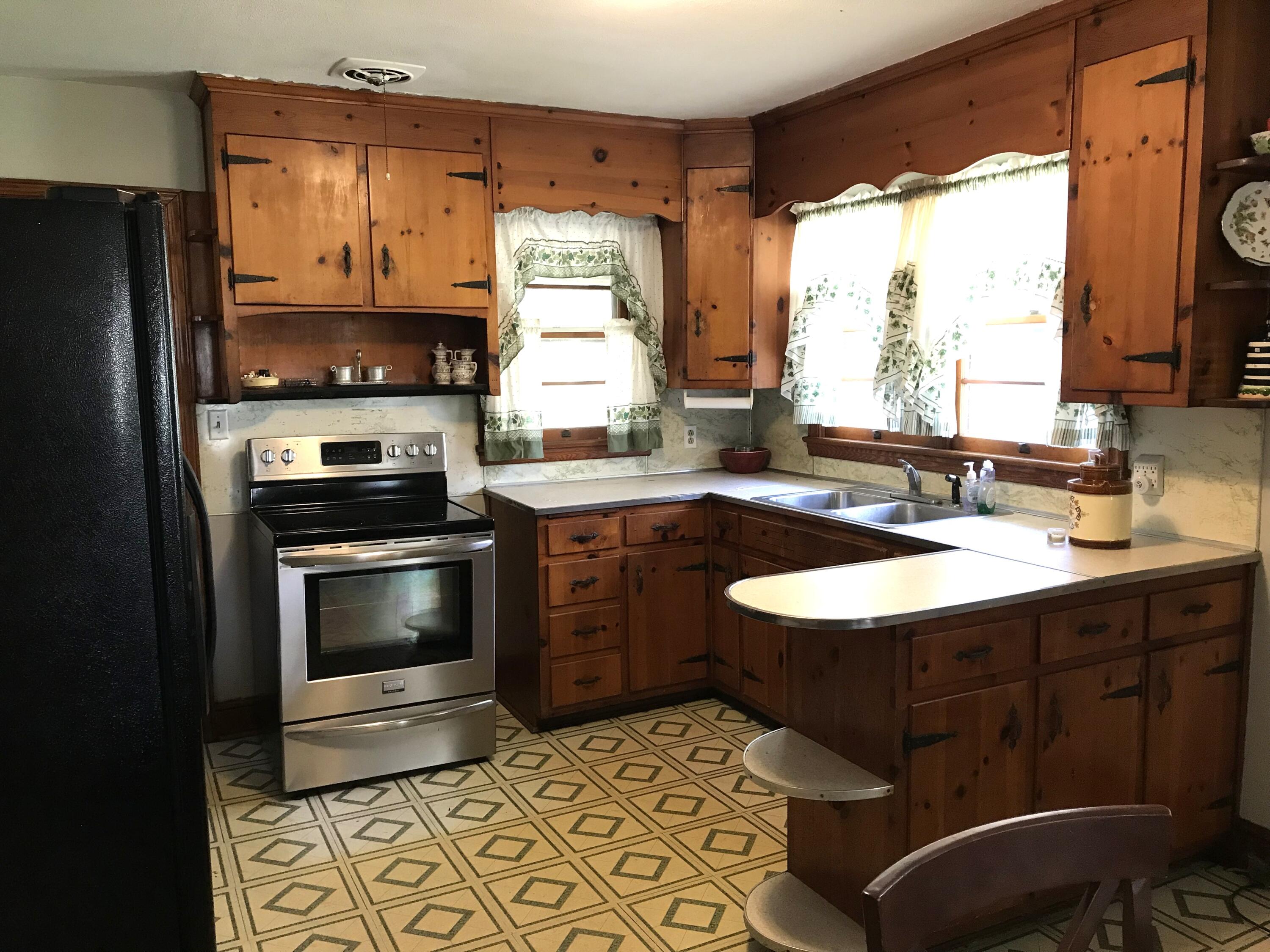 8180 Chatham Road Martinsville, VA 24112 - Photo 6 of 22 a kitchen with a sink stove and refrigerator