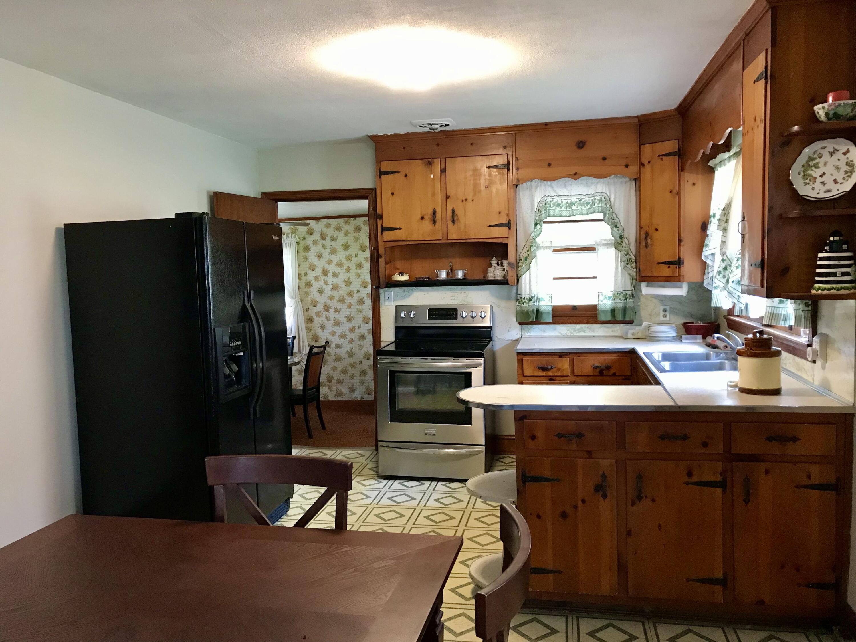 8180 Chatham Road Martinsville, VA 24112 - Photo 7 of 22 a kitchen that has a stove a refrigerator and a table in it