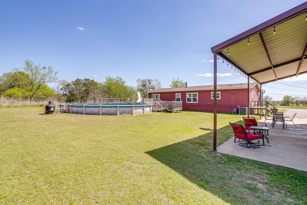 321 Young Road Millsap, TX 76066 - Photo 4 of 28 a view of a swimming pool with a lounge chairs