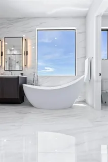 a living room with furniture and large windows