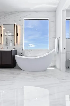 a living room with furniture and large windows