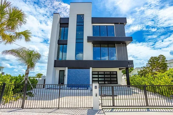 a living room with furniture and floor to ceiling window