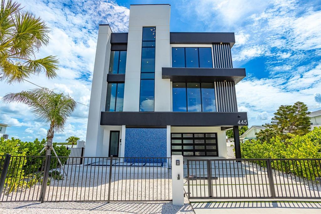 445 129th Avenue East Madeira Beach, FL 33708 - Photo 3 of 72 a view of front of a house with a iron gate