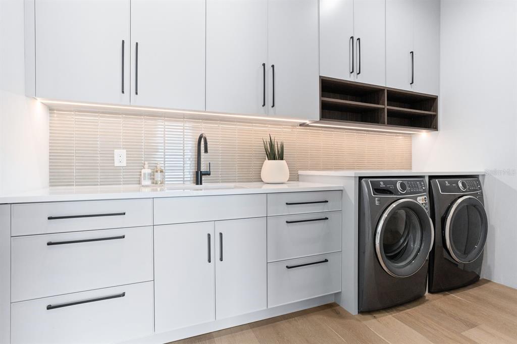 445 129th Avenue East Madeira Beach, FL 33708 - Photo 35 of 72 a utility room with sink dryer and washer