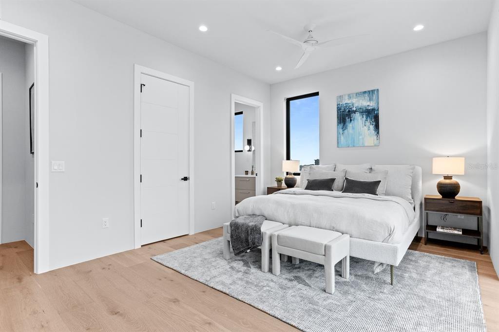 445 129th Avenue East Madeira Beach, FL 33708 - Photo 36 of 72 a spacious bedroom with a bed and a table