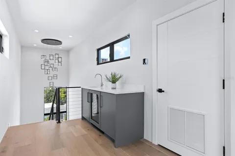 a living room with furniture pool table and potted plants