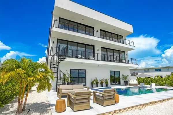 an aerial view of a houses with swimming pool and outdoor space