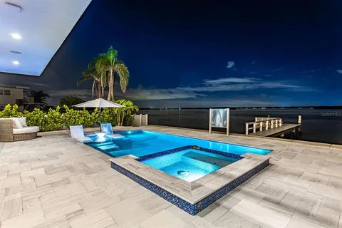 a view of a swimming pool with a bench in front of it