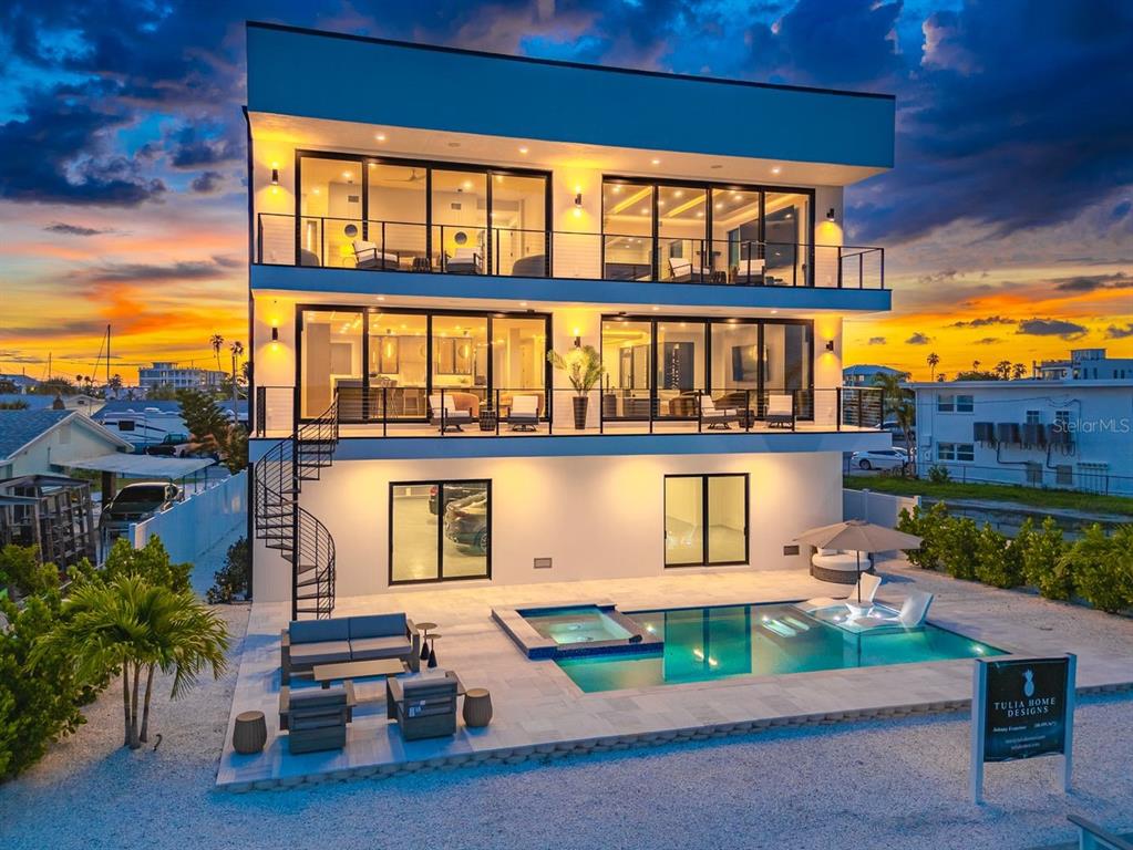 445 129th Avenue East Madeira Beach, FL 33708 - Photo 51 of 72 a front view of a house with a yard