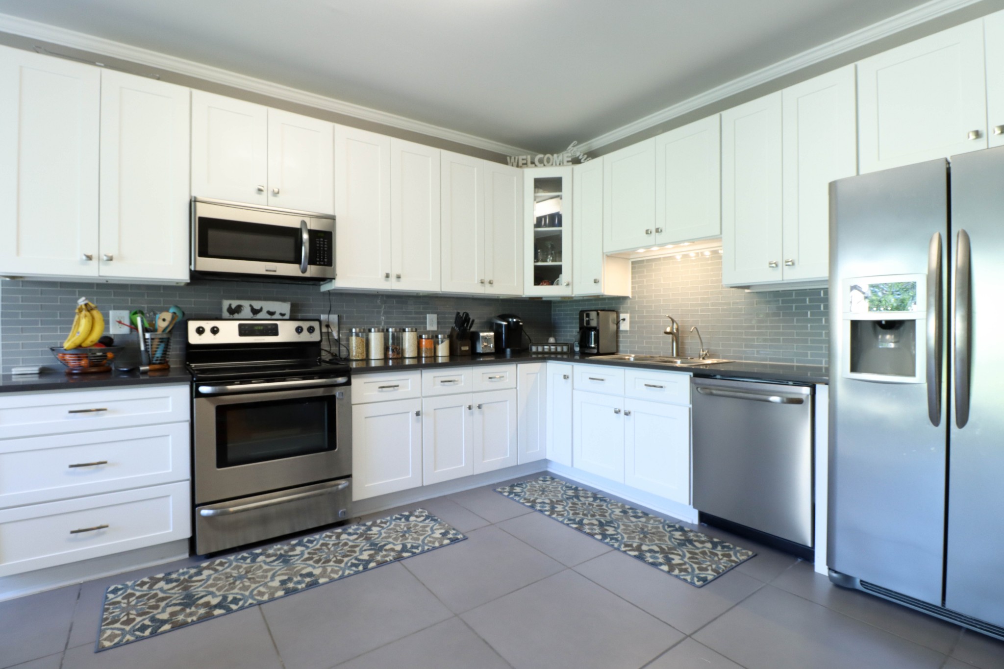 4170 Fizer Road Springfield, TN 37172 - Photo 7 of 21 a kitchen with a refrigerator stove and white cabinets
