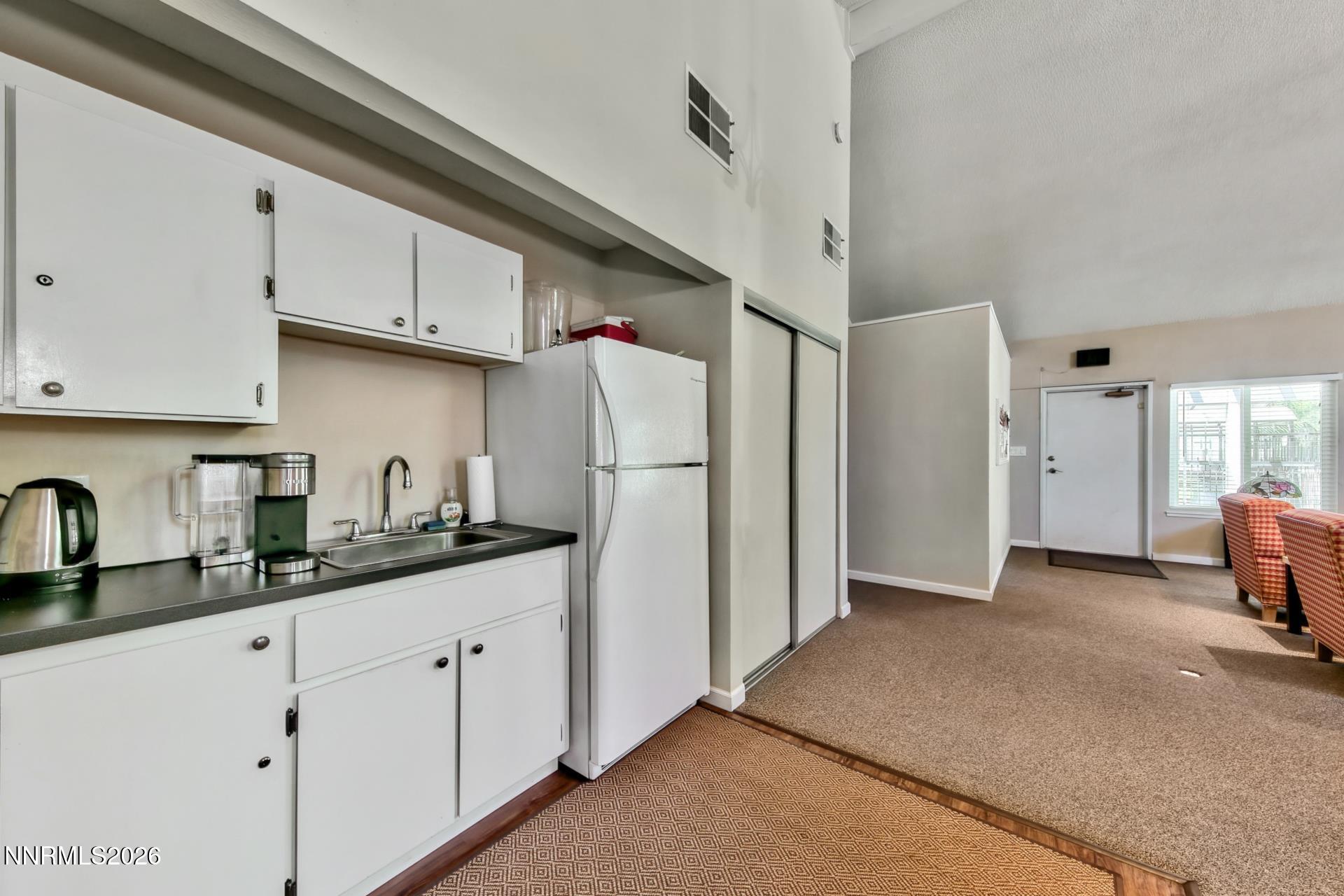 400 South Saliman Road, Unit 14 Carson City, NV 89701 - Photo 18 of 35 a kitchen with stainless steel appliances granite countertop a refrigerator sink and white cabinets