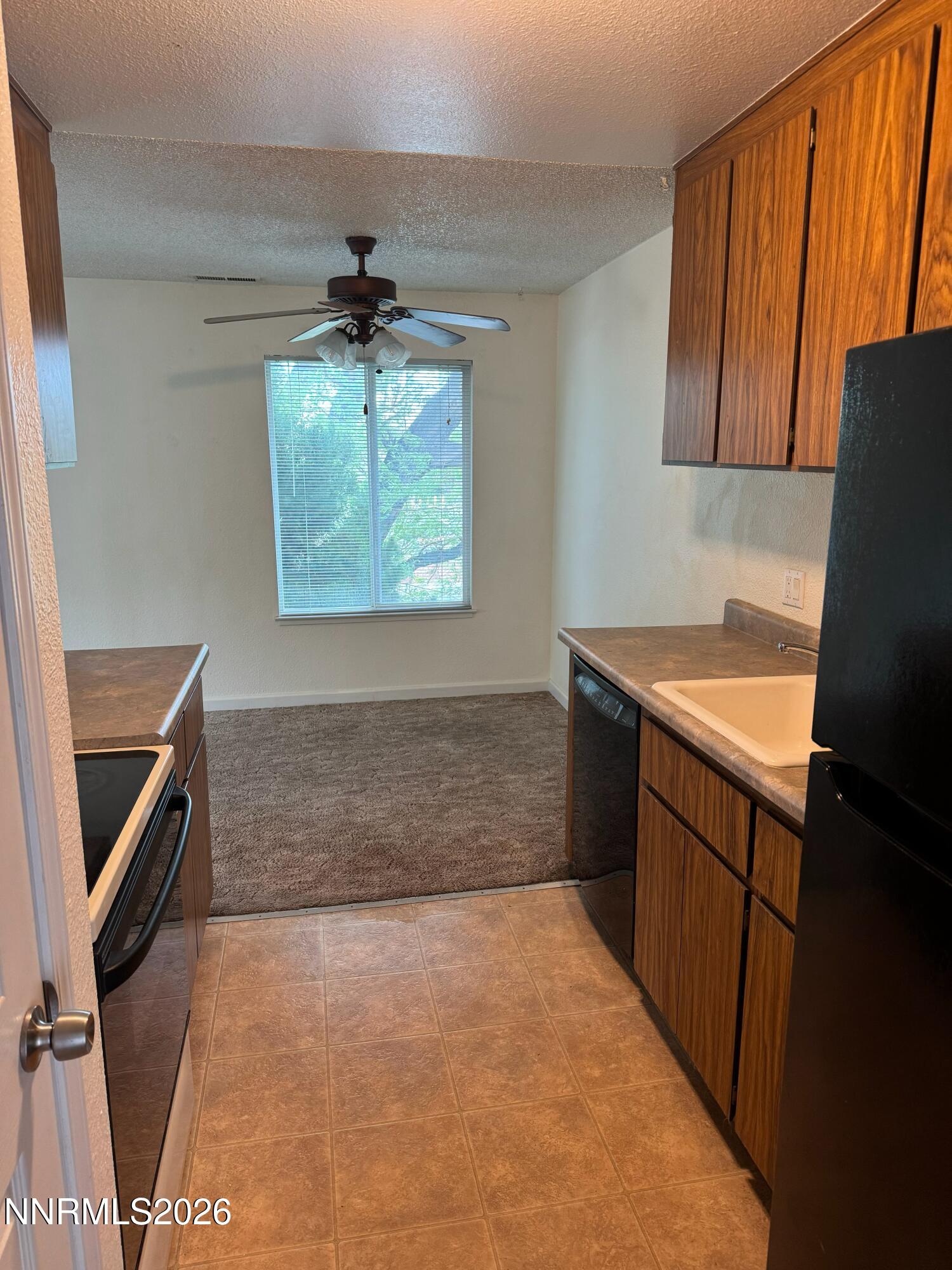400 South Saliman Road, Unit 14 Carson City, NV 89701 - Photo 34 of 35 a kitchen with a sink appliances and cabinets