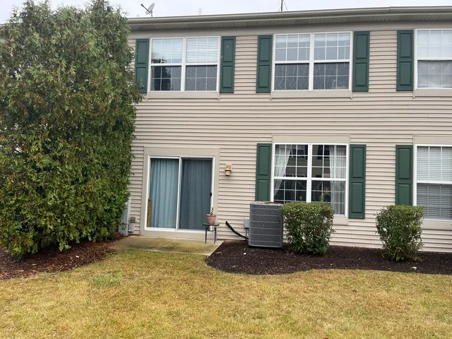 a view of a house with windows and yard