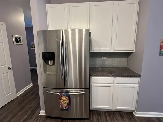 a kitchen with metallic refrigerator freezer and a dishwasher