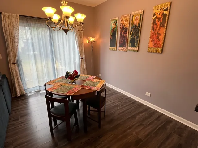 a dining room with furniture and window