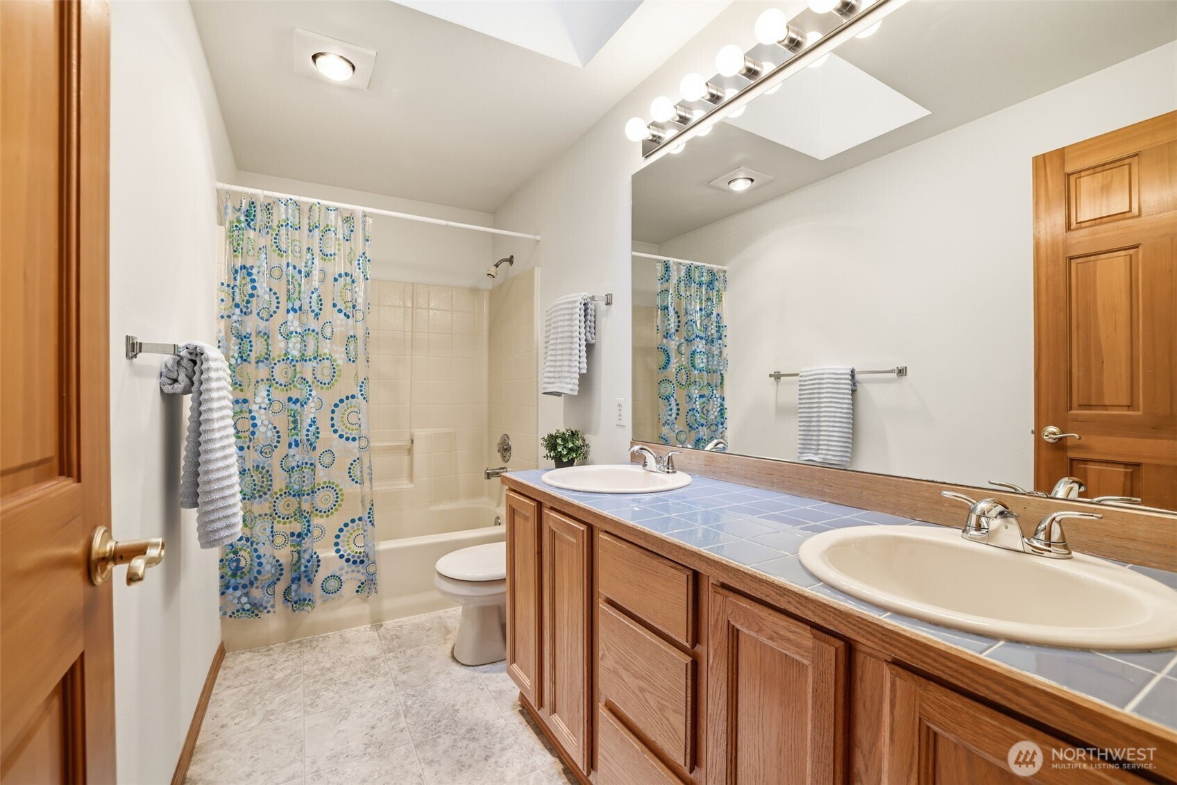32413 7th Avenue Southwest Federal Way, WA 98023 - Photo 21 of 39 a bathroom with a sink a toilet a mirror a vanity and shower