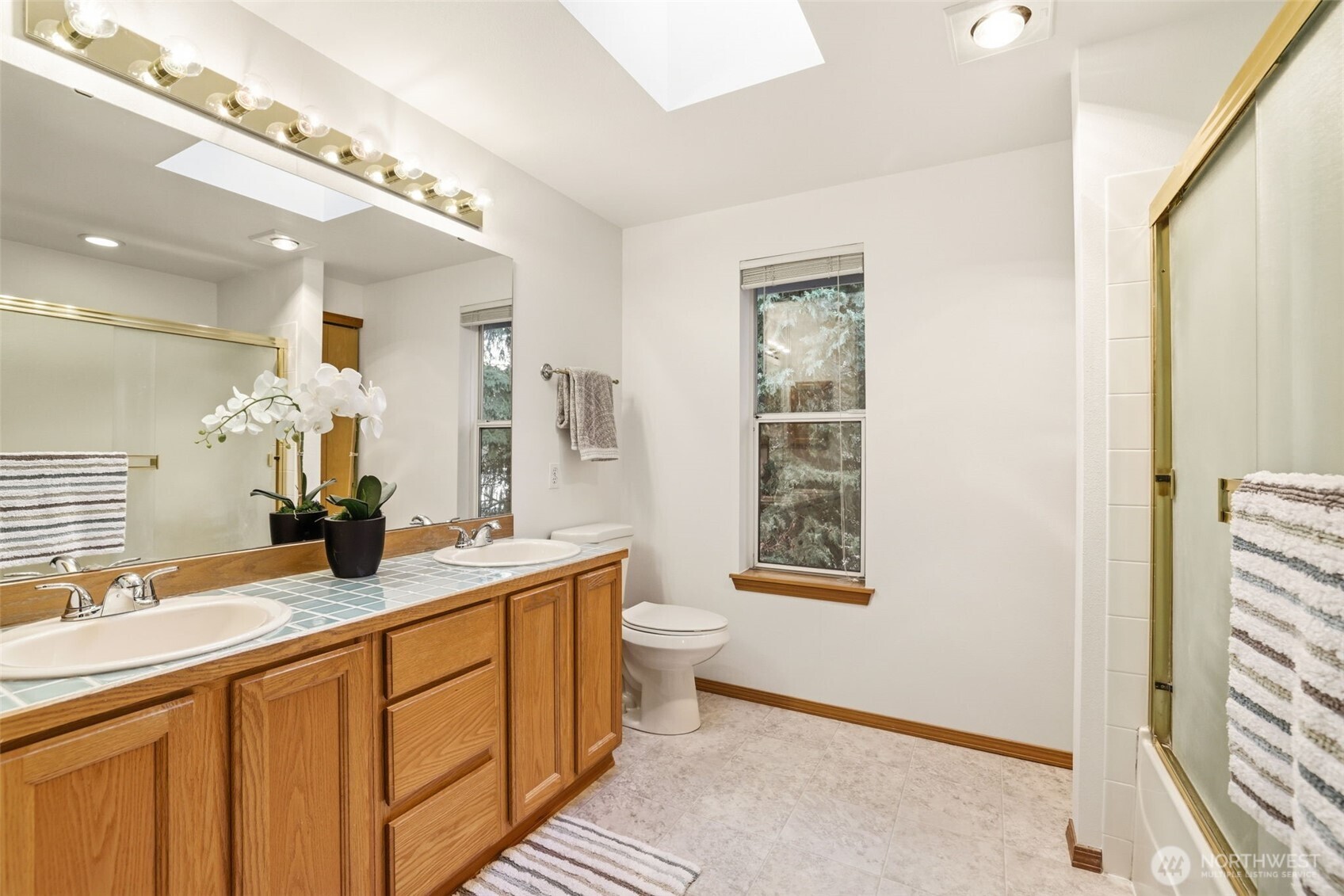 32413 7th Avenue Southwest Federal Way, WA 98023 - Photo 25 of 39 a bathroom with a double vanity sink a toilet and a mirror
