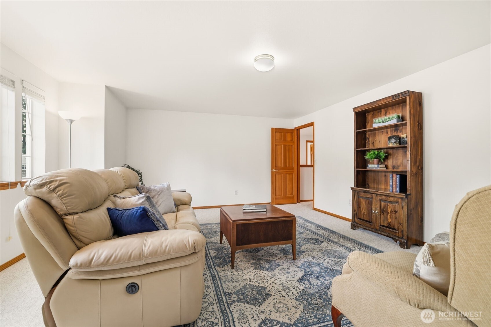 32413 7th Avenue Southwest Federal Way, WA 98023 - Photo 29 of 39 a living room with furniture a rug and a bookshelf