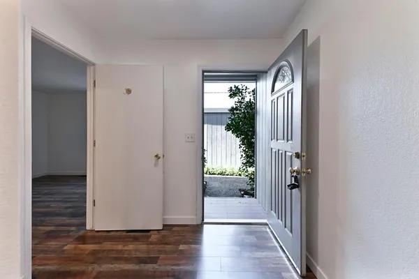 a view of entryway with livingroom and wooden floor