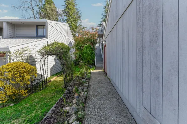 a front view of a house with potted plants
