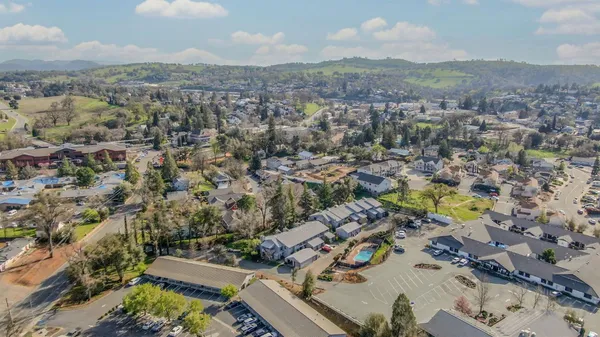 an aerial view of residential houses with outdoor space