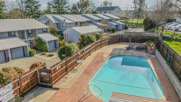 a view of a house with pool and chairs