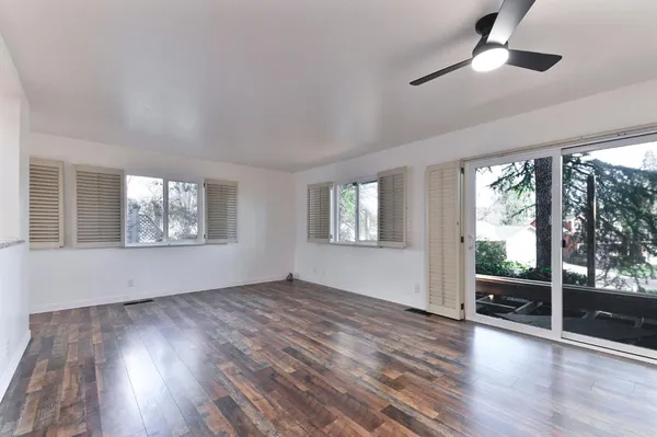 a view of kitchen appliances wooden floor and window