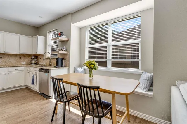 a view of a dining room with furniture and a window