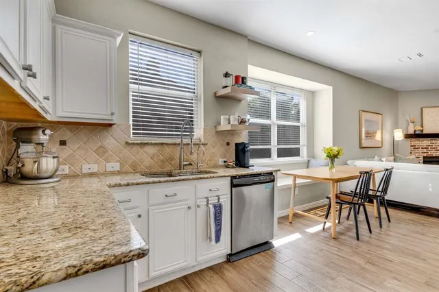 a kitchen with granite countertop wooden floor dining table and chairs