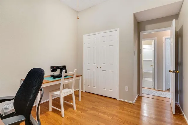a view of a workspace with furniture and wooden floor