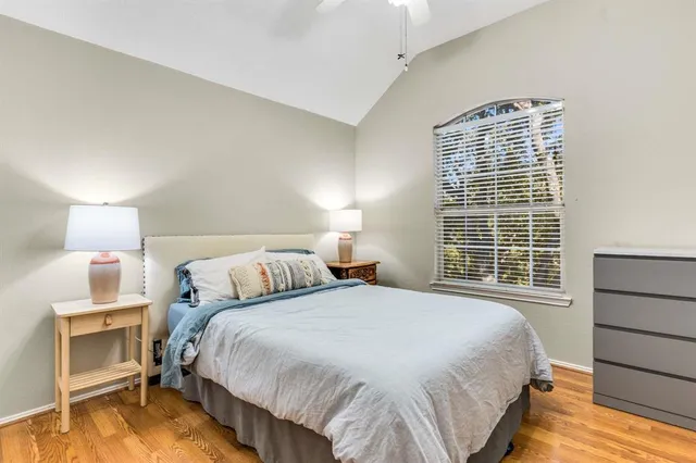 a bedroom with a bed and a night stand