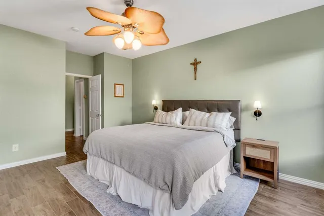 a bedroom with a bed and a chandelier